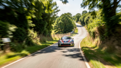 Race car speeding up the Prescott Speed Hill Climb course near Gotherington, Cheltenham